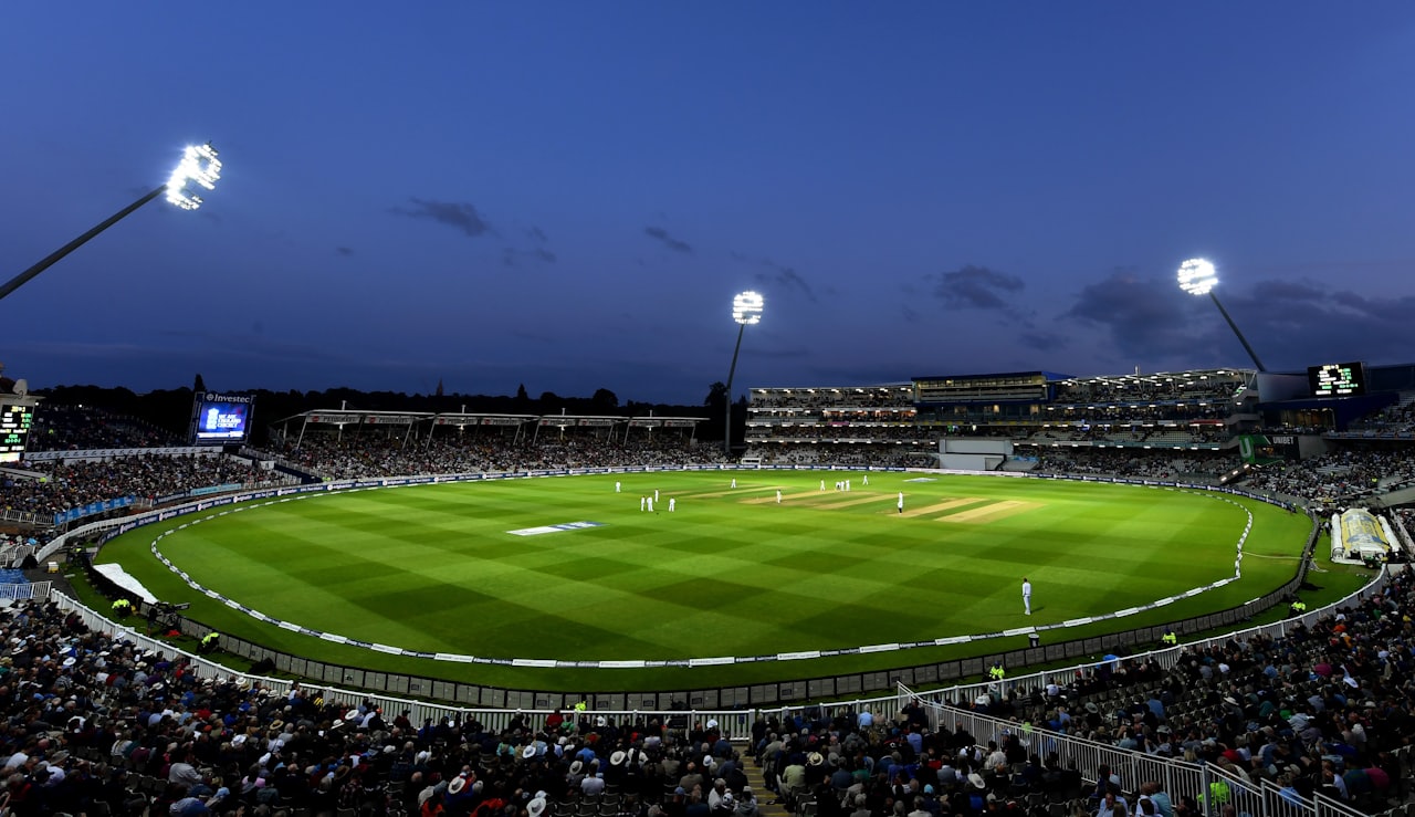 Cricket stadium under lights during a match